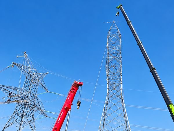 Mobile crane erecting a transmission tower for loop-in loop-out works
