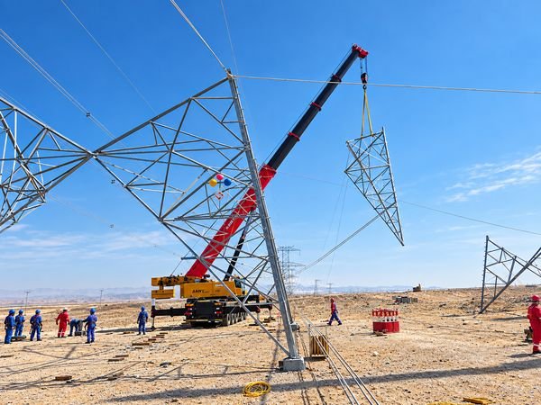 Bucket truck working on an overhead line beside a desert access road
