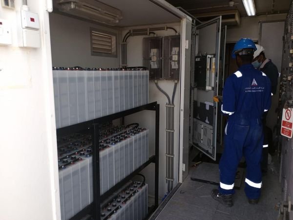 Electrician working inside an open distribution and metering panel