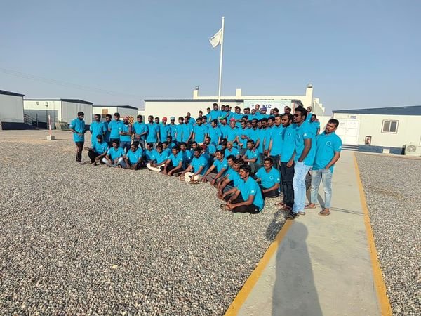 Site workforce assembled at a completed construction camp